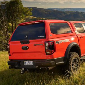 orange ford ranger parked in a field